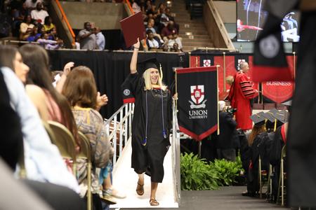 Lindsey Crowder, master of social work graduate, celebrates after receiving her diploma during fall commencement. - Photo by Kristi McMurry Woody