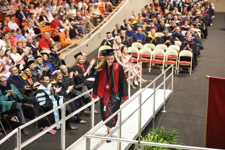 Janey Berends, Spanish and applied linguistics graduate, comes to the stage to receive the Tigrett Medal. - Photo by Kristi McMurry Woody