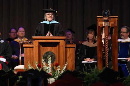 Dottie Myatt, retired university professor of education, delivers the commencement address during summer graduation. - Photo by Kristi McMurry Woody