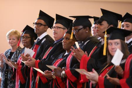 Graduates prepare to receive their diplomas during summer graduation. - Photo by Kristi McMurry Woody