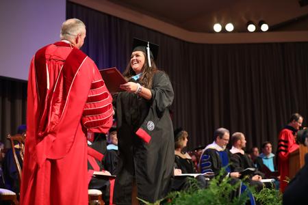 Sara Cowen, master of arts in education graduate, receives her diploma during summer graduation. - Photo by Kristi McMurry Woody