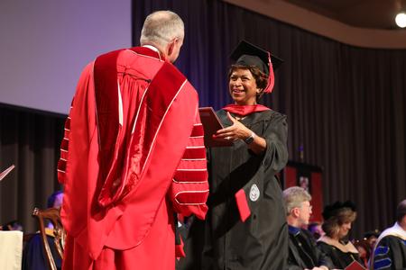 Elaine Hulon, master of Christian studies graduate, receives her diploma during summer graduation. - Photo by Kristi McMurry Woody