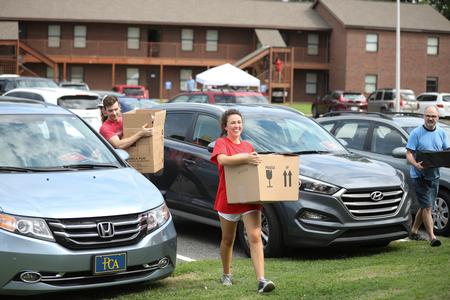 Delaney Sain, returning student, helps carry boxes for new students moving in. - Photo by Kristi McMurry Woody