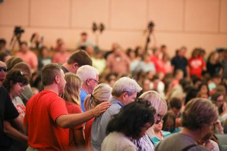 Families of new students surround them and pray for them during the Welcome Week blessing chapel. - Photo by Kristi McMurry Woody