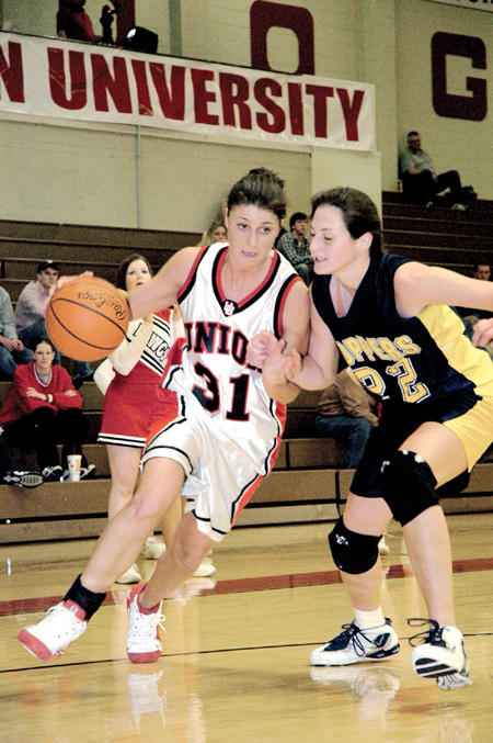 Freshman Merideth Richardson, learning
foundations major, focuses not only on her Blue Mountain opponent, but also on driving the ball to the basket. Union faced Blue Mountain College last Thursday where they were victorious. - Photo by Kathleen Murray