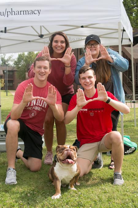 Returning students and staff pose with Buster during move-in day. - Photo by Hannah Heckart