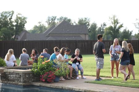 New students enjoy ice cream at the home of Dub and Susie Oliver, president and first lady of the university, during Welcome Week. - Photo by Kristi McMurry Woody