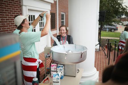 Members of Student Activities Council serve cotton candy to new students during the Welcome Week SAC Fest.  - Photo by Kristi McMurry Woody
