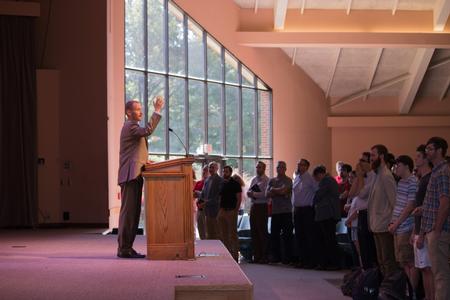 Dan Musselman, associate professor of music, leads the chapel congregation in a song at the beginning fo chapel. - Photo by Hannah Heckart