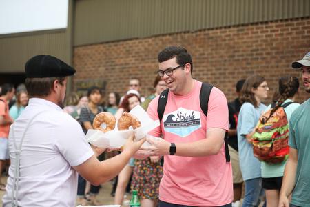 Caleb Stookey, accounting major, gets a donut from the donut truck during a break from Assessment Day. - Photo by Kristi McMurry Woody