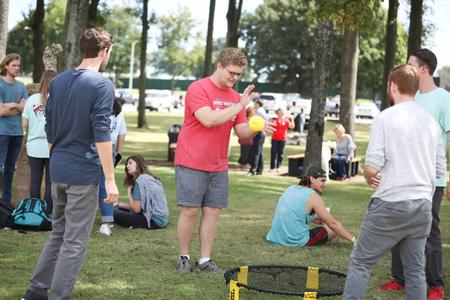 Luke Glidewell, business administration major, plays Spikeball during a break from Assessment Day. - Photo by Kristi McMurry Woody