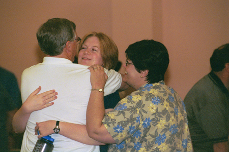 Freshman Christian Studies Major Alice Calvery says goodbye to her parents at the worship service on Saturday night during New Student Orientation 2002. - Photo by Justin Veneman