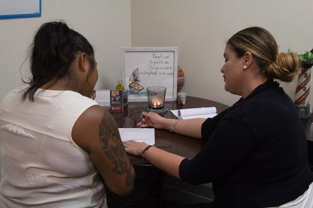 Esperanza Gonzalez (right), associate director for student success, helps a student with her resume during Walk-in Monday in the Vocatio Center.  - Photo by Lynn Tucker