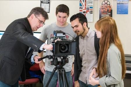 Chris Blair (left), professor of communication arts and coordinator of DMS, shows students some of the university's film equipment. - Photo by Kristi McMurry Woody