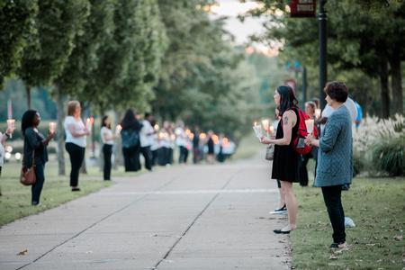 Social work students line the sidewalks of the Great Lawn for the annual Remember Me Walk.  - Photo by Kristi McMurry Woody
