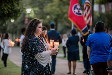 Social work students line the sidewalks of the Great Lawn during the annual Remember Me Walk. - Photo by Kristi McMurry Woody