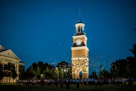 Guests of the annual Remember Me Walk hosted by the Center for Just and Caring Communities release balloons in memory of their loved ones lost to violence.  - Photo by Kristi McMurry Woody
