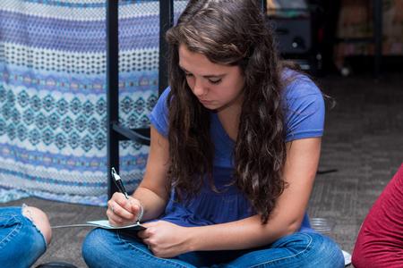 Students write letters to families in need of prayer during Global Focus Month's Henna Night. - Photo by Nikki Grim