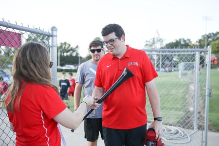 Caleb Stookey, accounting major, picks up his free vuvuzela for the soccer game during the Community Appreciation Event. - Photo by Kristi McMurry Woody