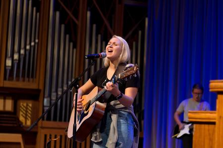 Lydia Shoemaker, junior music major, leads students and faculty in worship during chapel. - Photo by Nikki Grim