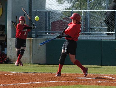 Holly Haycraft singles during Union's game with Lindsey Wilson.  Allison Shein (2) waits on deck. - Photo by Steven Aldridge
