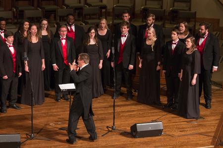 John Kinchen, professor of music and chair of the department, conducts during the Fall Choral Concert.  - Photo by Lynn Tucker