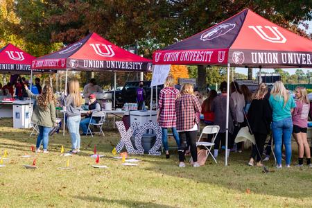 The ladies of Chi Omega set up their cake walk during the Forever Bulldogs Homecoming event on the Great Lawn. - Photo by Joey Echeverria