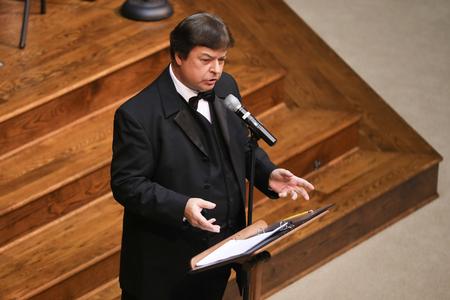 Michael Mann, assistant professor of music, addresses the audience during the Symphonic Band's fall concert. - Photo by Kristi McMurry Woody