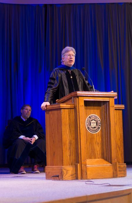 Mark Bolyard, university professor of biology and Faculty Member of the Year, speaks in chapel. - Photo by Nikki Grim