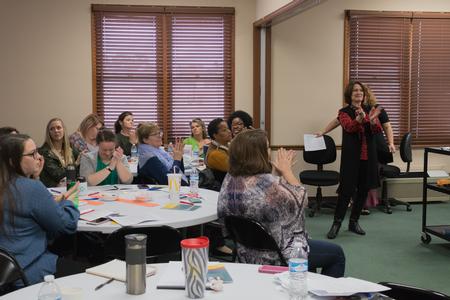 Participants of "Naked and Afraid: Social Work Ethics Stripped Down" applaud the presenter. - Photo by Lynn Tucker