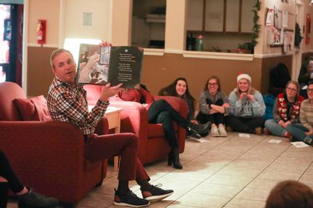 Dub Oliver, president of the university, reads "Twas the Night Before Christmas" during Christmas with the Olivers in McAfee Commons. - Photo by Kristi McMurry Woody