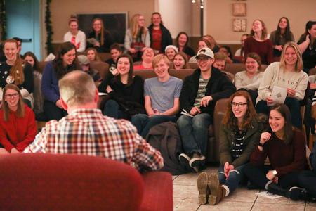 Students in McAfee Commons enjoy listing to Dub Oliver, president of the university, reading "Twas the Night Before Christmas." - Photo by Kristi McMurry Woody