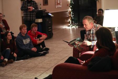 Dub Oliver, president of the university, reads "Twas the Night Before Christmas" during Christmas with the Olivers. - Photo by Kristi McMurry Woody