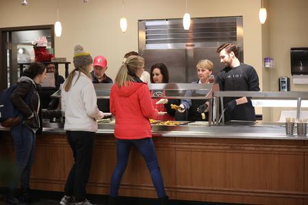 Faculty and staff serve students a late-night breakfast during Food for Finals. - Photo by Kristi McMurry Woody