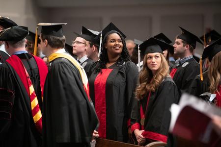 Nasharya Lake and Emily McLeod, fall 2018 graduates, look for family and friends in the crowd at West Jackson Baptist Church. - Photo by Kristi McMurry Woody