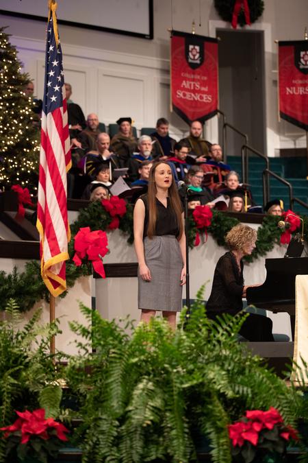 Shelby Morris, music education major, sings "His Eye is on the Sparrow" during Fall Commencement. - Photo by Kristi McMurry Woody