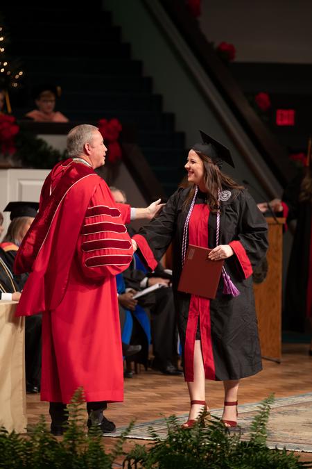 Susan Tuders, nursing graduate, receives her diploma during Fall Commencement. - Photo by Kristi McMurry Woody