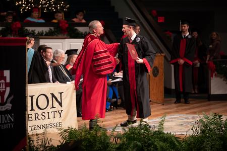 Andy Mayfield, theological studies graduate, receives his diploma during Fall Commencement. - Photo by Kristi McMurry Woody
