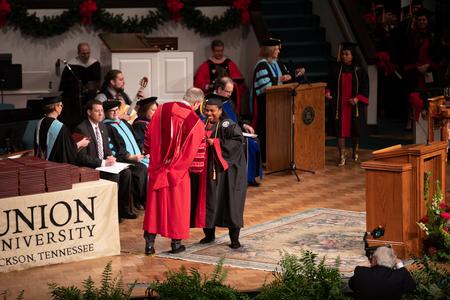 Tonya Blunt, organizational leadership graduate, receives her diploma during the second Fall Commencement service.  - Photo by Kristi McMurry Woody