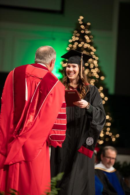 Audrey Cunningham, MBA graduate, receives her diploma during Fall Commencement. - Photo by Kristi McMurry Woody