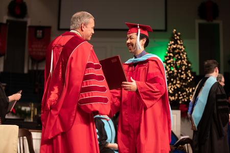 Shu Aoki, doctor of education graduate, receives his diploma during Fall Commencement. - Photo by Kristi McMurry Woody