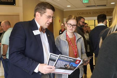 Ray Van Neste, dean of the School of Theology & Missions, talks with a prospective student during Day at the U. - Photo by Sarah Palmer Goff