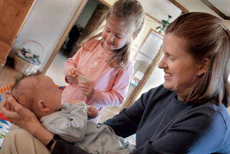 <i>Salazar Family C&C Profile</i> - Keri and youngest daughter Lizzie play with 2-month-old Josiah. - Photo by Kristen Nicole Sayres
