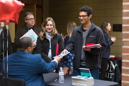 Students get their books signed by American poet Marcus Wicker. - Photo by Nikki Grim