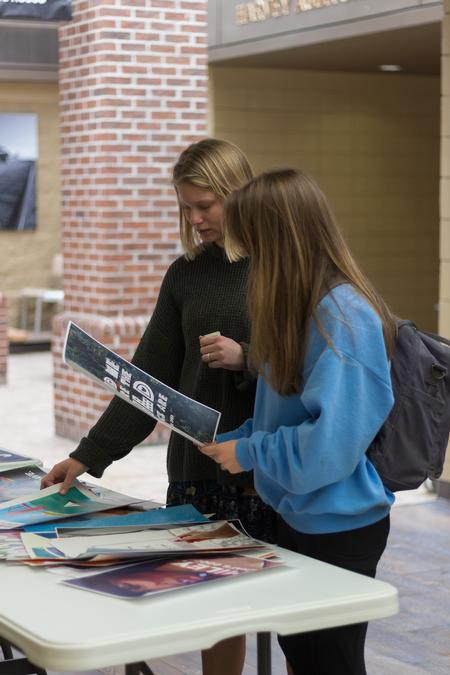 Students look through posters offered for sale by AIGA graphic design students. - Photo by Nikki Grim