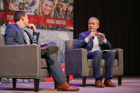 Chad Wilson, chairman of the board of trustees, talks with Dub Oliver, president of the university, during chapel. - Photo by Hannah Heckart
