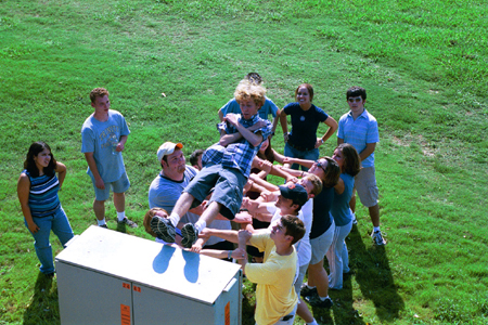 Brad Spencer takes the plunge into the arms of his FOCUS group during New Student Orientation 2002. - Photo by Justin Veneman