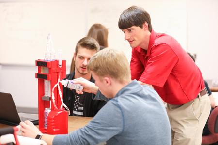 Georg Pingen, associate professor of engineering, helps his students with their final project. - Photo by Kristi McMurry Woody