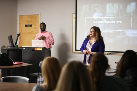 Karen Martin, professor of language, welcomes guests to the language department's Scholarship Symposium presentations. - Photo by Kristi McMurry Woody