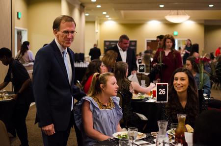 Gary Johnson, professor of physical education and department chair, mingles during the first Top Dawg Awards Night.  - Photo by Jess Newendyke